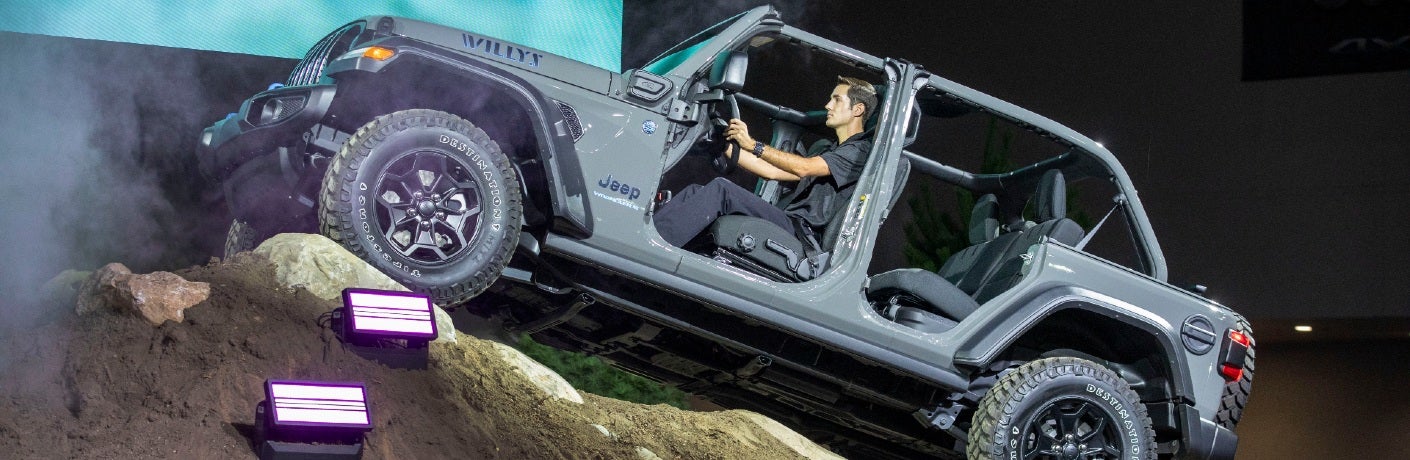 man driving jeep wrangler willys 4xe
